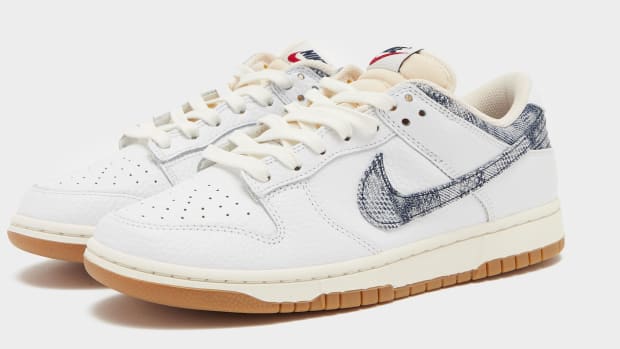 Side view of white and blue Nike Dunk sneakers.